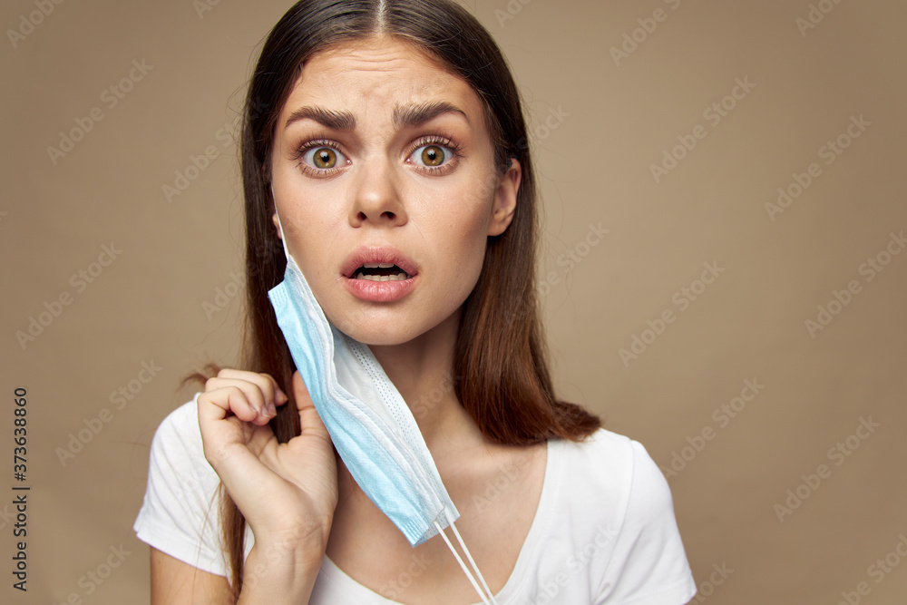 Girl with medical mask in hand scared look health problems Girl with medical mask in hand scared look health problems