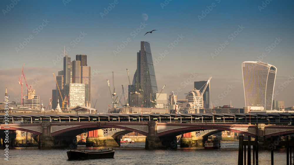 City of London, London, Britain. 20 January 2016. After another day of freezing temperatures in London a beautiful sunset ends the day, City of London with Moon Rise