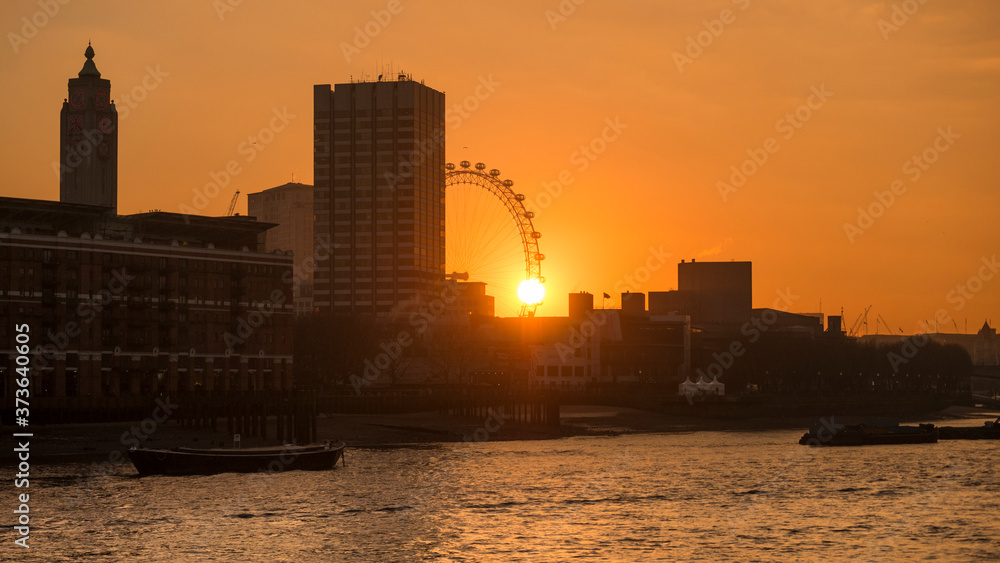 London, Britain. 20 January 2016. Sunset ends the day over The Millennium Wheel and The South Bank.