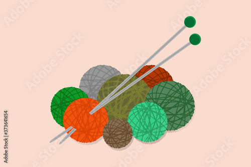 knitting needles and threads for knitting orange, green, brown, gray and turquoise in balls on a light background