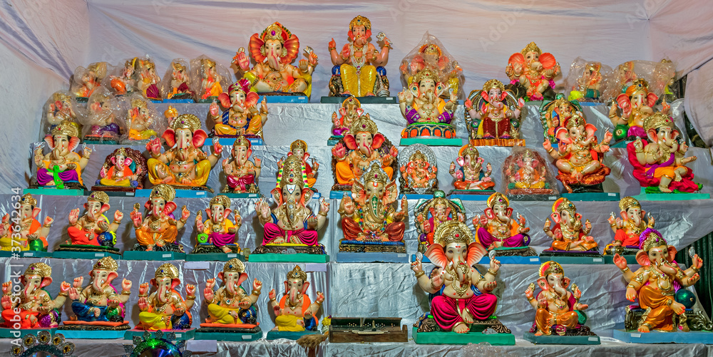 Colorful clay made idols of Hindu god Lord Ganesha ready for sale at a stall.