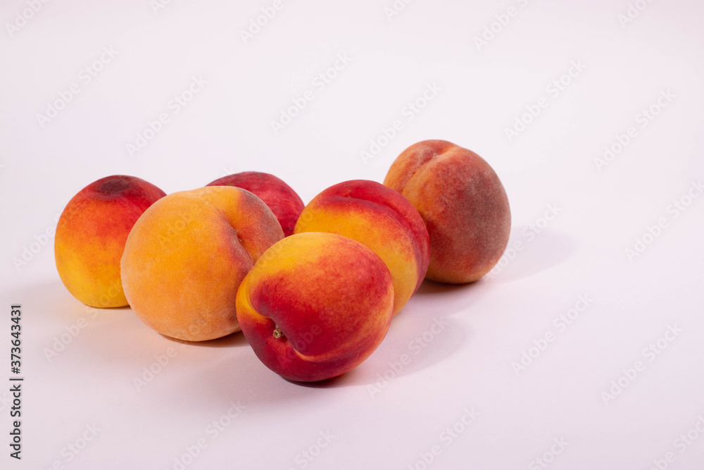 a group of round peaches on the light background a group of round peaches on the light background