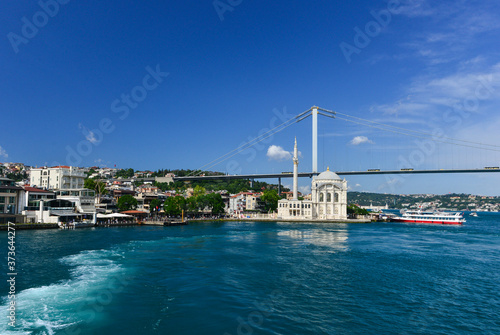 Istanbul cityscape, including Bosphorus bridge and Ortakoy Mosque as seen from a passenger boat - Istanbul, Turkey photo