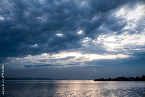 cloudy sky over the sea. the sky after the rain. clouds are reflected in the water. Summer evening in nature. River and reflection. Miserable summer