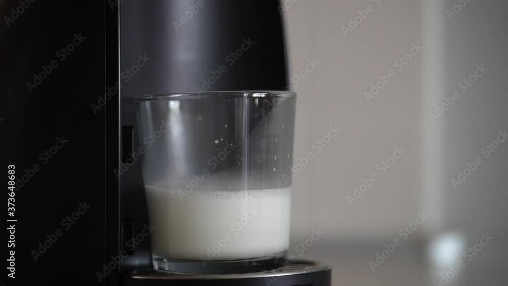 Home capsule coffee machine prepares a cup of fresh cappuccino Home capsule coffee machine prepares a cup of fresh cappuccino