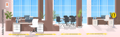 workplace desks with yellow arrows signs for social distancing coronavirus epidemic protection measures office interior horizontal vector illustration