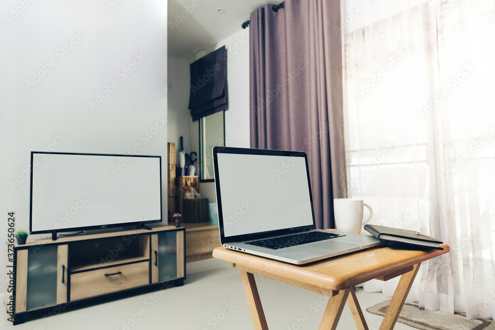 do the working  at home by using laptop on small desk in front of television  at living room in my house with evening coffee.