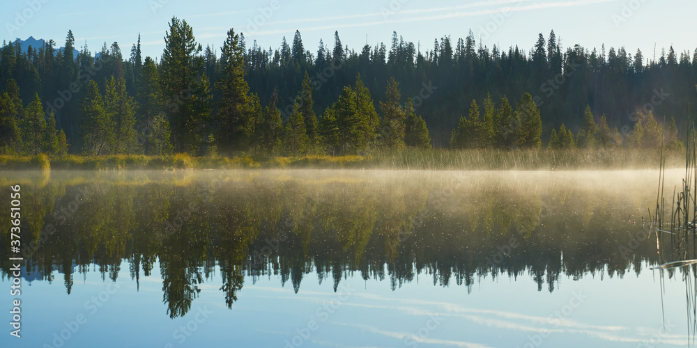 Misty morning panorama on the Hosmer Lake in central Oregon.