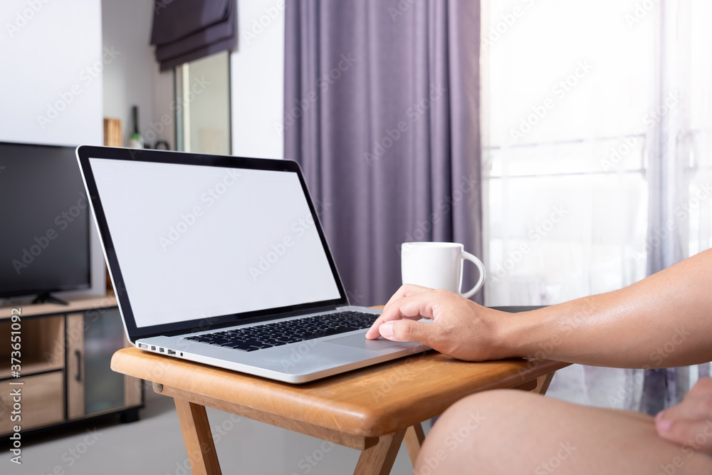 do the working at home by using laptop on small desk in front of television at living room in my house with evening coffee. do the working at home by using laptop on small desk in front of television at living room in my house with evening coffee.