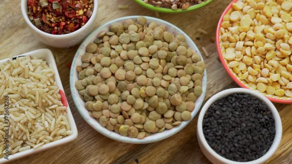 Bean Cereals Spices Seeds Macro Rotate on a Wooden Surface, Isolated. The Concept Of A Healthy Vegan Diet. Bean Cereals Spices Seeds Macro Rotate on a Wooden Surface, Isolated. The Concept Of A Healthy Vegan Diet.