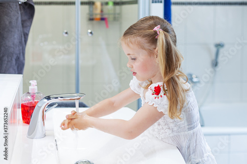 little girl washing hands photo