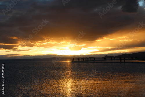 Sunset view of Namtso lake with the human silhouette and dramatic sky  Tibet  China