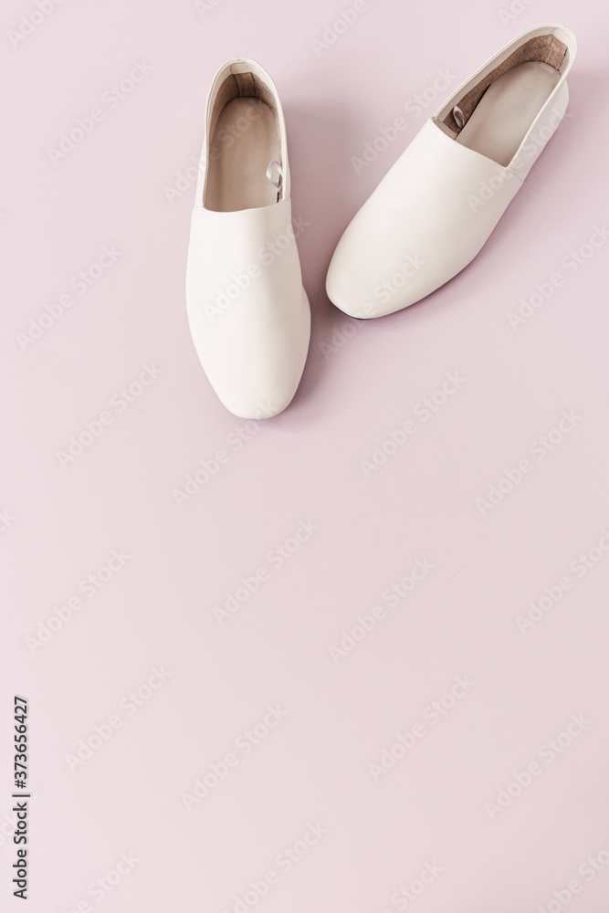 Fashion collage with women's white leather slippers on pink. Minimal flat lay, top view lifestyle concept. Fashion collage with women's white leather slippers on pink. Minimal flat lay, top view lifestyle concept.