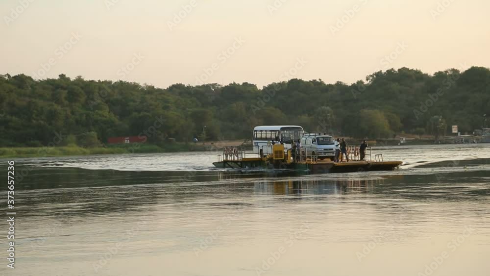 ars and children going down from a ferry on the Nile, Uganda ars and children going down from a ferry on the Nile, Uganda