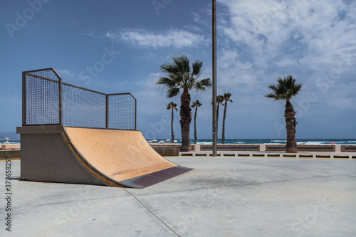 Empty skate park ramp outdoor in seaside beach photo