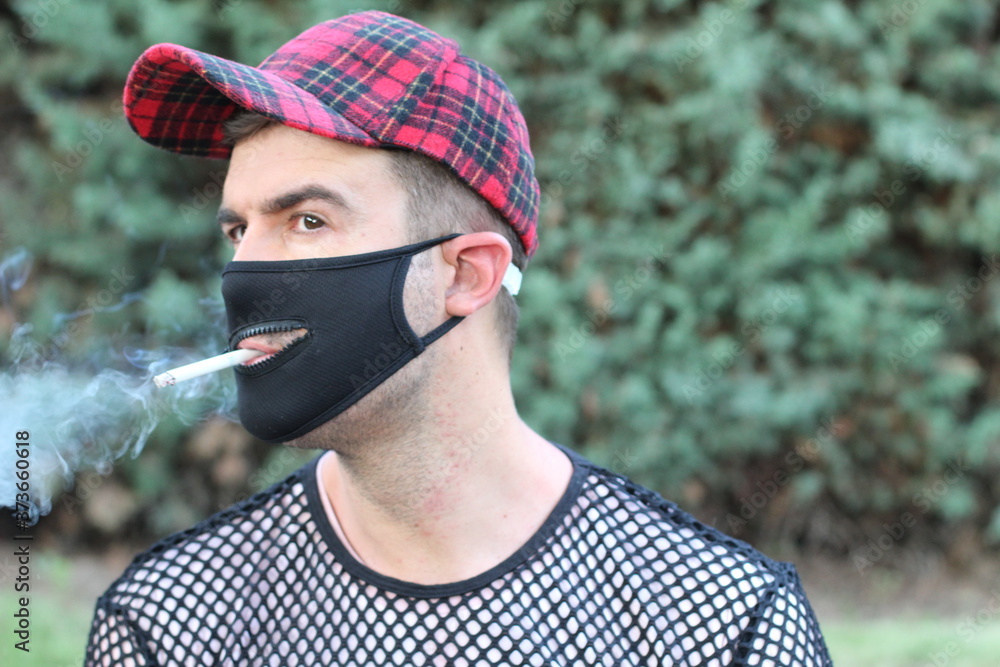 Smoker wearing protective mask with a zipper Smoker wearing protective mask with a zipper