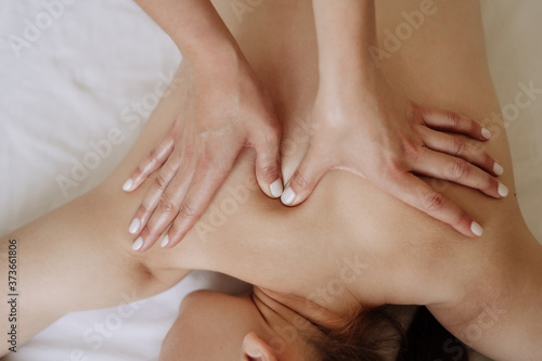 Fototapeta Naklejka Na Ścianę i Meble -  Masseur Make Healthy Massage Woman Back Top View