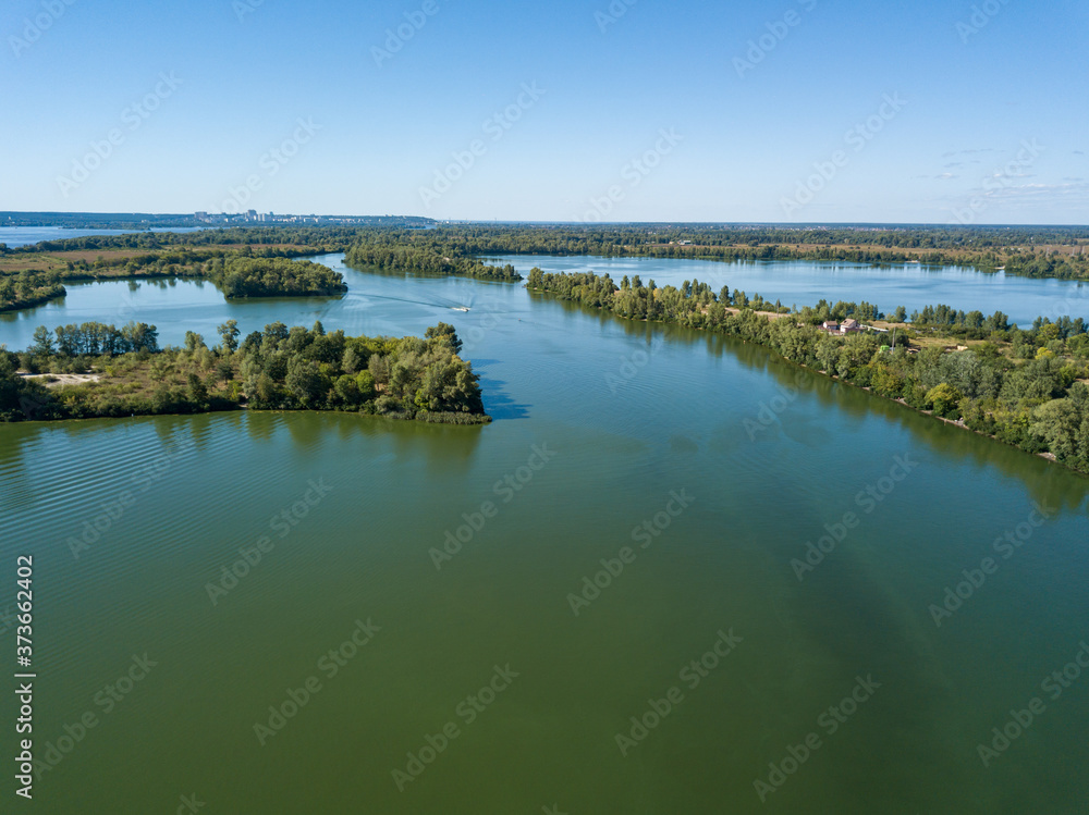 Panoramic view of the Dnieper river in Kiev. Sunny clear day. Aerial drone view.