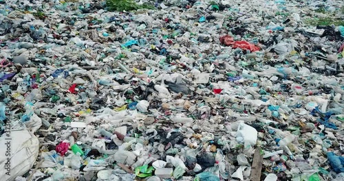 Garbage in the canals after the flood. Contaminated rivers with plastic waste.