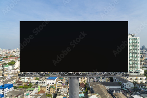 Blank black road billboard with Bangkok cityscape background at day time. Street advertising poster, mock up, 3D rendering. Front view. The concept of marketing communication to promote or sell idea.