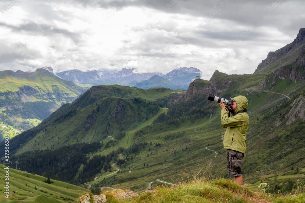 Photographer with telephoto lens in mountain landscape Photographer with telephoto lens in mountain landscape