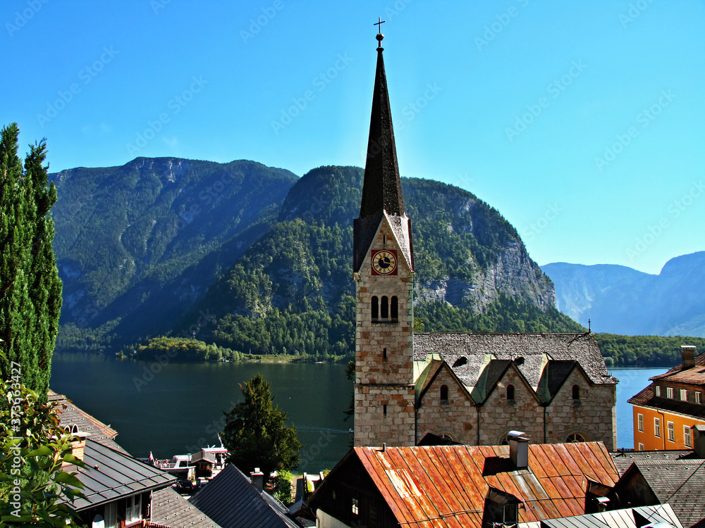 Austrian Alps-view of the church tower in town Hallstatt and lake ...