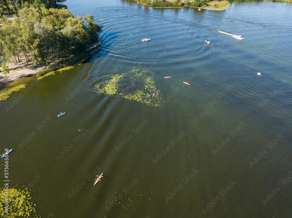 Kayak boat in the green water of the Dnieper river. Aerial drone view. Kayak boat in the green water of the Dnieper river. Aerial drone view.