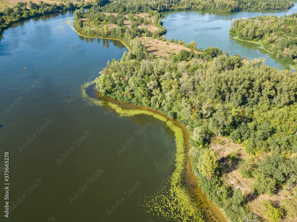 Green bank of the Dnieper river on a summer sunny day. Aerial drone view. Green bank of the Dnieper river on a summer sunny day. Aerial drone view.