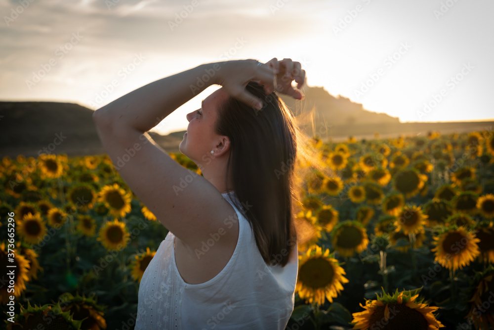 beautiful young woman in a field of sunflowers