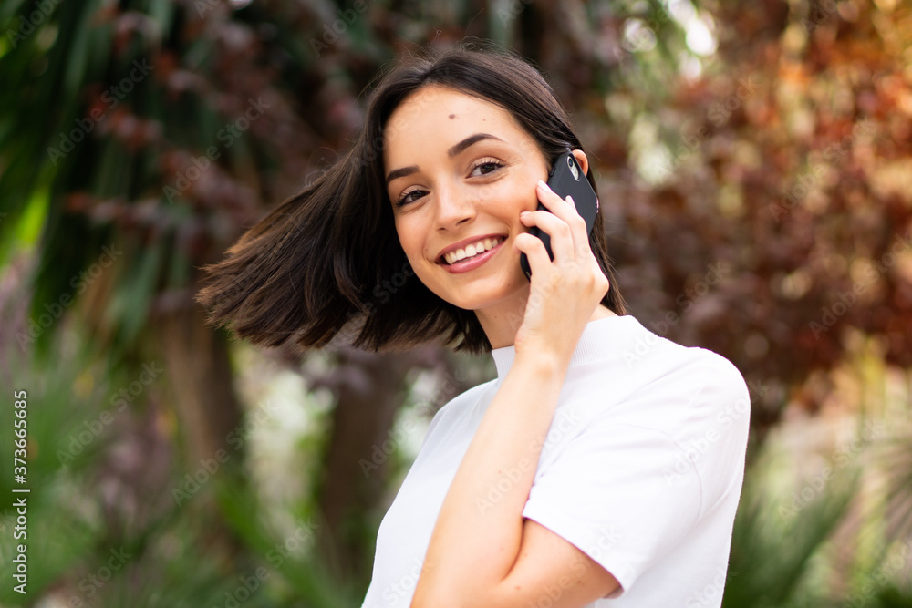 Young caucasian woman using a phone at outdoors Young caucasian woman using a phone at outdoors