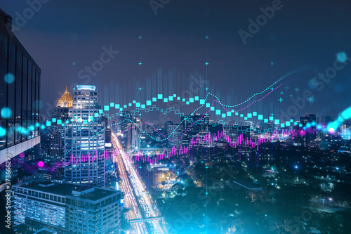 FOREX graph hologram, aerial night panoramic cityscape of Bangkok, the developed location for stock market researchers in Asia. The concept of fundamental analysis. Double exposure. © VideoFlow
