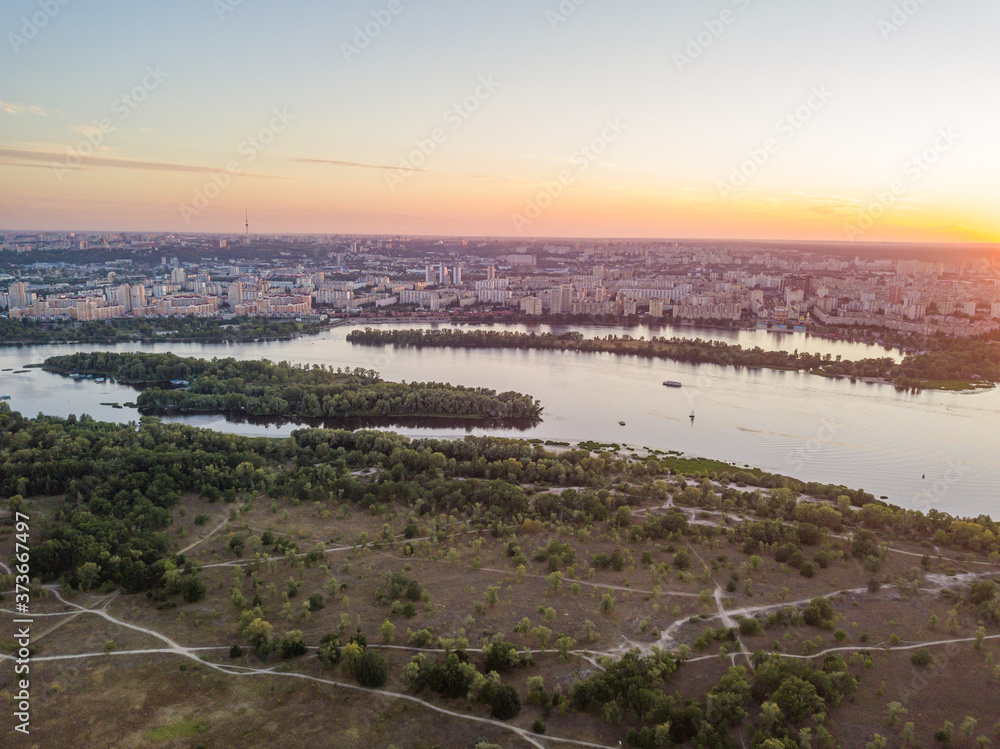 Obraz premium Aerial drone view. Sunset over the Dnieper River and the city of Kiev.