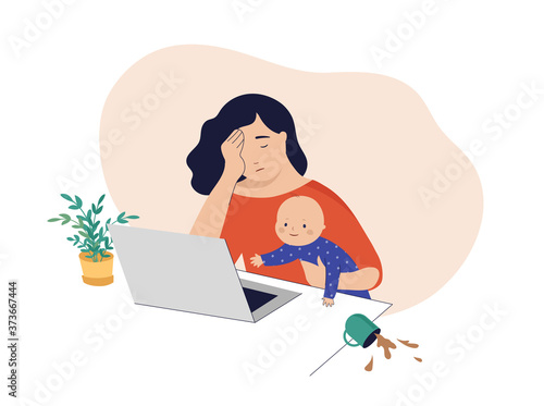 Tired mom trying to work, holding baby in her arms