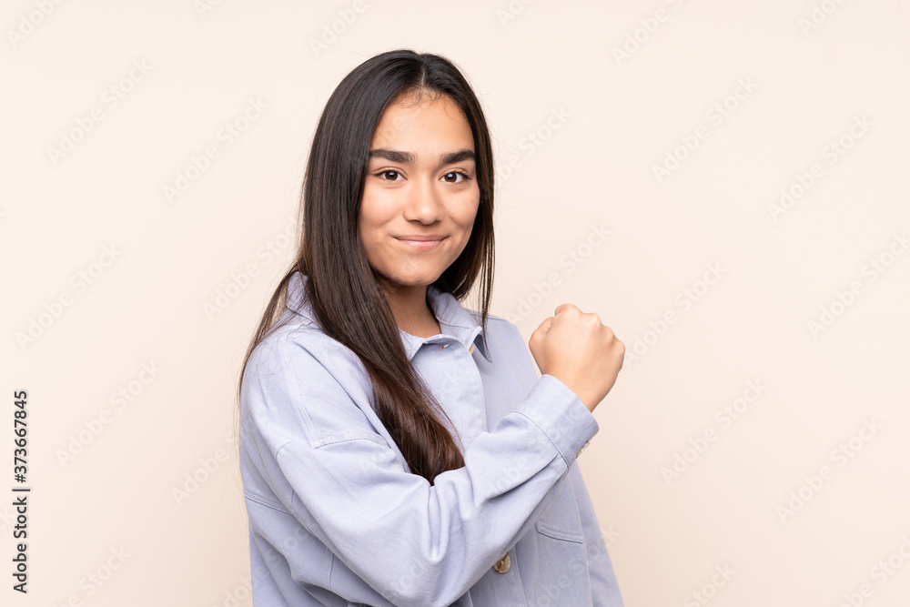 Young Indian woman isolated on beige background proud and self-satisfied Young Indian woman isolated on beige background proud and self-satisfied