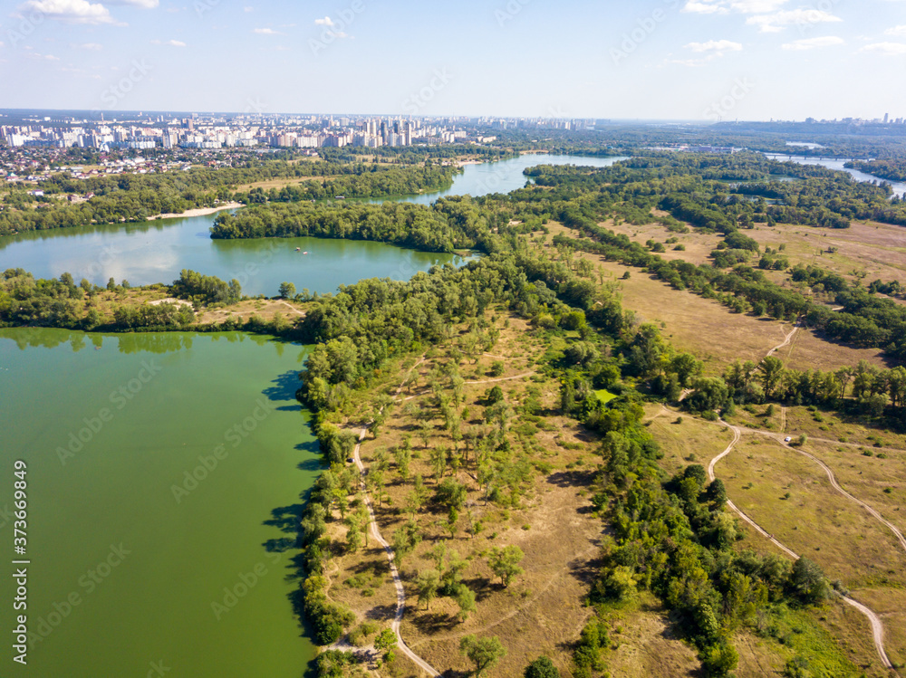 Panoramic view of the Dnieper river in Kiev. Sunny clear day. Aerial drone view.