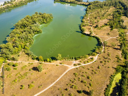 Aerial view. Bank of the Dnieper River. Algae bloom in the green water of the river.