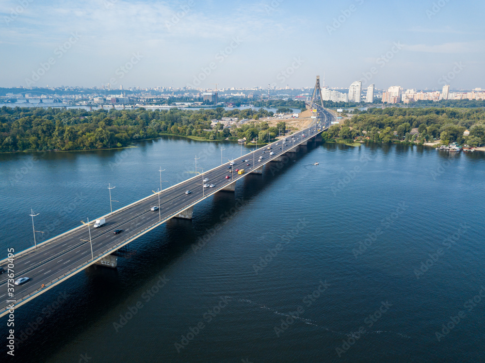 Fototapeta premium Dnieper River and North Bridge in Kiev. Sunny summer day, aerial drone view.