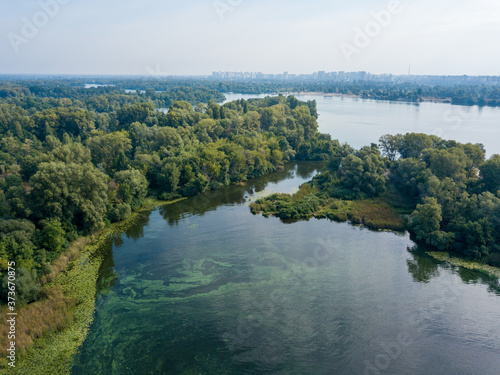 Aerial drone view. Green bank of the Dnieper river on a summer sunny day. © Sergey