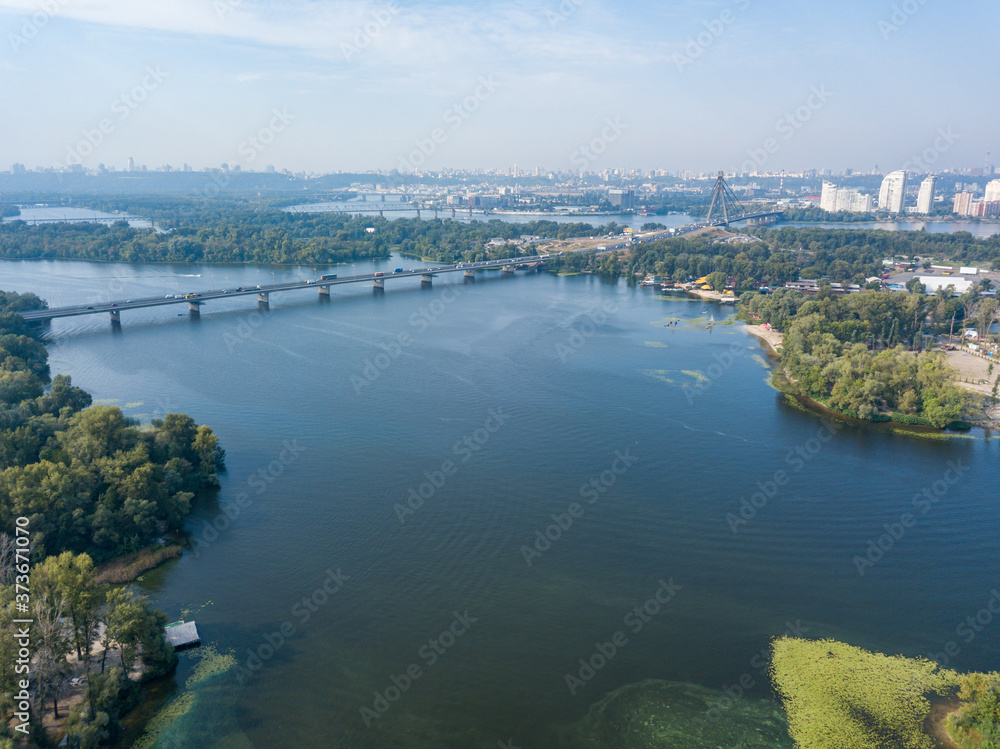 Aerial drone view of the Dnieper River in Kiev. Clear sunny day. Aerial drone view of the Dnieper River in Kiev. Clear sunny day.