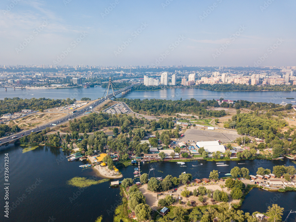 Fototapeta premium Dnieper River and North Bridge in Kiev. Sunny summer day, aerial drone view.