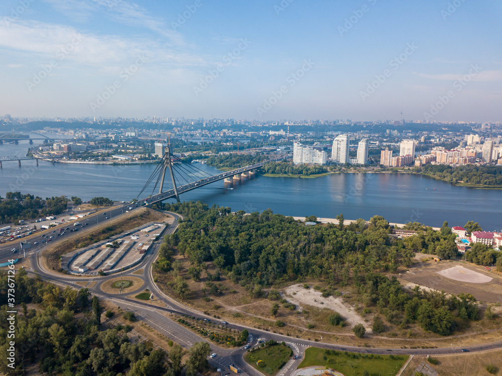 Dnieper River and North Bridge in Kiev. Sunny summer day, aerial drone view.