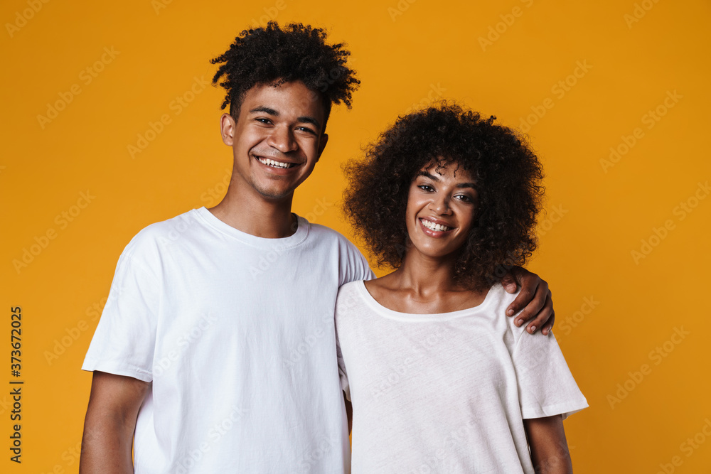 Image of happy african american couple hugging and smiling at camera Image of happy african american couple hugging and smiling at camera