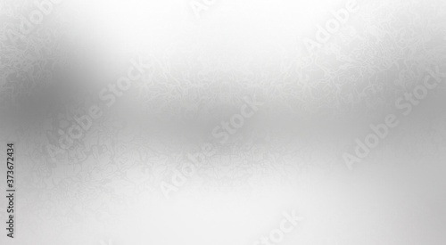 Irregular streaks pattern on transparent glass abstract texture. White grey defocus polished background.