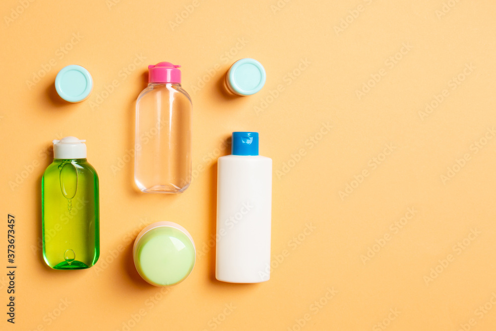 Cosmetics SPA branding mock-up, top view with copy space. set of tubes and jars of cream flat lay on colored background Cosmetics SPA branding mock-up, top view with copy space. set of tubes and jars of cream flat lay on colored background