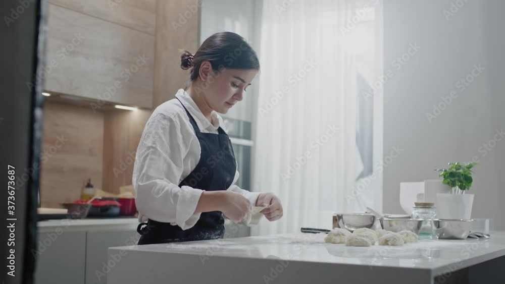 Professional Baker Female Makes Buns Shape. Professional Baker Female Makes Buns Shape.