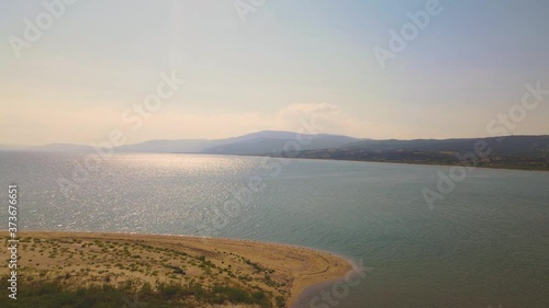 4K aerial drone clip flying sideways over the peninsula  over the beach near Strymonas river in Macedonia, Greece