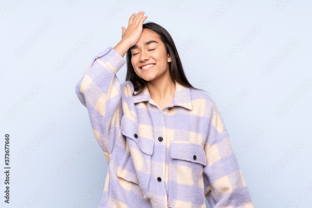 Young Indian woman isolated on blue background has realized something and intending the solution Young Indian woman isolated on blue background has realized something and intending the solution
