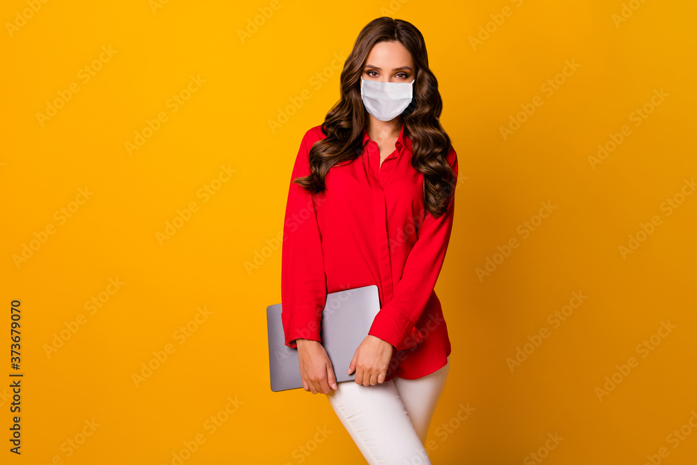 Portrait of her she attractive gorgeous wavy-haired girl wearing safety mask carrying laptop keep social distance stop pandemia isolated bright vivid shine vibrant yellow color background Portrait of her she attractive gorgeous wavy-haired girl wearing safety mask carrying laptop keep social distance stop pandemia isolated bright vivid shine vibrant yellow color background
