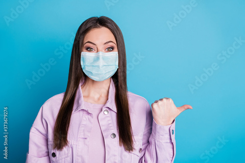 Close-up portrait of her she nice attractive confident healthy girl wearing gauze safety mask showing copy space mers cov pneumonia prevention isolated bright vivid shine vibrant blue color background