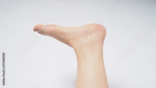 close up of man barefoot on white background
